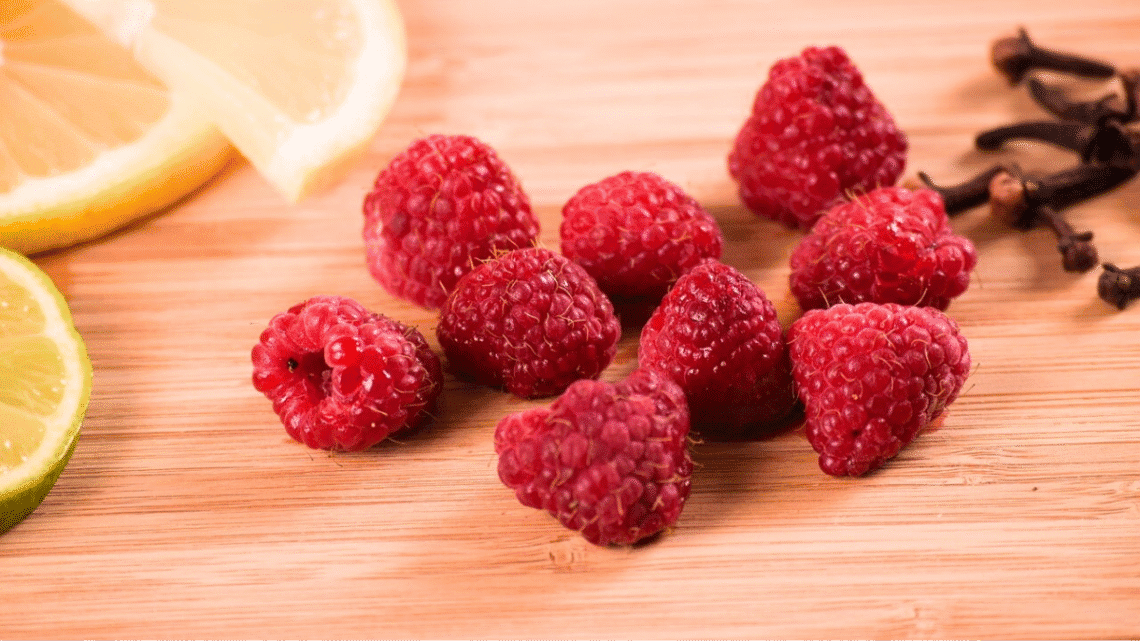 A vibrant flat lay of brain-boosting foods including berries and lemon on a rustic wooden table representing the food for brainhealth.