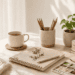 Bright minimalist workspace with a notebook, tea, plants, and art supplies in natural light, representing low budget hobbies to try without commitment.